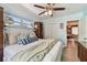 Comfortable bedroom with a ceiling fan, wooden floors, and doorway to the living room at 905 8Th Sw Ave, Largo, FL 33770