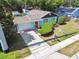 Charming single-story home featuring a colorful exterior, well-manicured landscaping, and a spacious driveway at 905 8Th Sw Ave, Largo, FL 33770