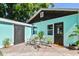 Back exterior view of the renovated shed featuring a new door and seating area at 905 8Th Sw Ave, Largo, FL 33770