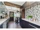 Modern kitchen boasts dark cabinetry, stainless steel appliances, and a breakfast nook by the back door at 905 8Th Sw Ave, Largo, FL 33770