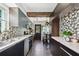 Modern kitchen features stylish mosaic tile backsplash, stainless steel appliances, and dark wood cabinetry at 905 8Th Sw Ave, Largo, FL 33770