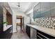 Modern kitchen featuring stylish blue cabinets, stainless steel appliances, and a unique tile backsplash at 905 8Th Sw Ave, Largo, FL 33770
