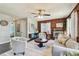 Cozy living room features a decorative fireplace and wood-paneled walls, enhanced by natural light and modern decor at 905 8Th Sw Ave, Largo, FL 33770