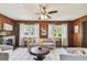 Bright living room features a decorative fireplace and wood-paneled walls, enhanced by natural light and neutral decor at 905 8Th Sw Ave, Largo, FL 33770