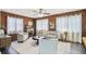 Cozy living room features a decorative fireplace and wood-paneled walls, enhanced by natural light and modern decor at 905 8Th Sw Ave, Largo, FL 33770