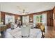 Bright living room features a decorative fireplace and wood-paneled walls, enhanced by natural light and neutral decor at 905 8Th Sw Ave, Largo, FL 33770