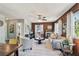 Cozy living room features a decorative fireplace and wood-paneled walls, enhanced by natural light and modern decor at 905 8Th Sw Ave, Largo, FL 33770