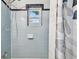 Clean shower area with blue tiles, a window, and a shower head at 905 8Th Sw Ave, Largo, FL 33770