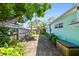 A view of the home's side yard showcasing the fenced perimeter, plants, and storage box at 905 8Th Sw Ave, Largo, FL 33770