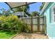 Side yard featuring a privacy fence, tropical plants, new artificial turf, and possible RV parking at 905 8Th Sw Ave, Largo, FL 33770