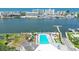 Community aerial view of sparkling pool and playground with bay views and waterway access at 10216 Regal Dr # 310, Largo, FL 33774