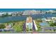 Aerial view showcases resort-style living with pools, tennis courts, manicured lawns, and waterfront access at 10216 Regal Dr # 310, Largo, FL 33774