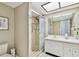 Bathroom featuring a tiled shower, vanity, and mirrored closet at 10216 Regal Dr # 310, Largo, FL 33774