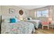 Bedroom featuring two beds with vibrant comforters and coordinating decor at 10216 Regal Dr # 310, Largo, FL 33774