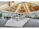 Spacious clubhouse with high wood ceilings, ceiling fans, tables, and comfortable seating area at 10216 Regal Dr # 310, Largo, FL 33774