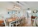 Bright dining room with a view into the kitchen and featuring modern light fixture and wooden flooring at 10216 Regal Dr # 310, Largo, FL 33774