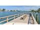 Community dock with seating area, bench, and trash receptacle at 10216 Regal Dr # 310, Largo, FL 33774