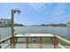 Dock with a table, light, and hose, overlooking peaceful waters and buildings at 10216 Regal Dr # 310, Largo, FL 33774