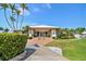 Exterior of clubhouse featuring well-maintained landscaping and convenient ramp access at 10216 Regal Dr # 310, Largo, FL 33774