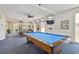 Bright recreational game room featuring several billiard tables and ceiling fans at 10216 Regal Dr # 310, Largo, FL 33774