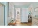 Hallway with hardwood floors and doorways to the bathroom and dining area at 10216 Regal Dr # 310, Largo, FL 33774
