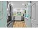 Modern kitchen featuring stainless steel appliances, white cabinets and light countertop at 10216 Regal Dr # 310, Largo, FL 33774