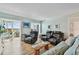 Comfortable living room with reclining chairs, a wooden coffee table, and access to a screened balcony at 10216 Regal Dr # 310, Largo, FL 33774