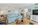 Inviting living room open to the dining area featuring a plush sofa and coastal decor at 10216 Regal Dr # 310, Largo, FL 33774