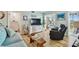 Cozy living area with entertainment center, sofa, recliner, beach decor, and views to the lanai at 10216 Regal Dr # 310, Largo, FL 33774