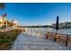 Charming lounge area with white Adirondack chairs overlooking the serene waterfront at 10216 Regal Dr # 310, Largo, FL 33774