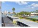 Community parking area featuring assigned covered parking, tennis courts, and a view of the intracoastal at 10216 Regal Dr # 310, Largo, FL 33774