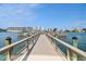 Picturesque wooden pier with railings overlooking the tranquil water and waterfront buildings at 10216 Regal Dr # 310, Largo, FL 33774