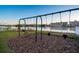 Community playground with swings and green space overlooking the water at 10216 Regal Dr # 310, Largo, FL 33774