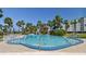 Relaxing pool area featuring palm trees and lounge chairs for resident enjoyment in a resort-style setting at 10216 Regal Dr # 310, Largo, FL 33774