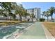 Shuffleboard courts surrounded by lush landscaping and tropical palm trees at 10216 Regal Dr # 310, Largo, FL 33774