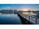 Beautiful waterfront views from the private dock with buildings illuminated by the sunset at 10216 Regal Dr # 310, Largo, FL 33774