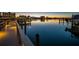 Sunset view from the dock on the waterfront with boat slips and tranquil water views reflecting the city lights at 10216 Regal Dr # 310, Largo, FL 33774