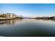 Scenic waterfront view featuring calm waters and buildings reflecting under the serene blue sky at 10216 Regal Dr # 310, Largo, FL 33774