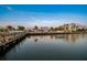 Tranquil waterfront view showcasing docks, palm trees, and buildings reflecting on the serene water at 10216 Regal Dr # 310, Largo, FL 33774