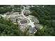Community aerial shot shows homes nestled among green trees and community ponds, connected by winding roads at 10305 Worthy Lamb Way, New Port Richey, FL 34654