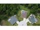 This aerial view showcases lovely homes nestled amongst lush green trees, some with private pools at 10305 Worthy Lamb Way, New Port Richey, FL 34654