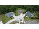 Aerial view of homes in a neighborhood with wooded lots at 10305 Worthy Lamb Way, New Port Richey, FL 34654