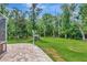 Spacious backyard showcasing lush greenery and a covered gazebo at 10305 Worthy Lamb Way, New Port Richey, FL 34654