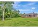 Expansive backyard with a screened in patio, mature trees and lush lawn at 10305 Worthy Lamb Way, New Port Richey, FL 34654