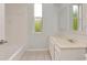 Clean bathroom with a white tub and vanity at 10305 Worthy Lamb Way, New Port Richey, FL 34654