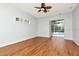 Bedroom with hardwood floors, ceiling fan and sliding doors leading to the outdoor pool at 10305 Worthy Lamb Way, New Port Richey, FL 34654