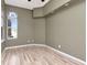 Cozy bedroom featuring stylish wood floors, a window, and a calming atmosphere at 10305 Worthy Lamb Way, New Port Richey, FL 34654
