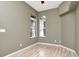 Comfortable bedroom showcasing wood floors, two bright windows, and ample space for relaxation at 10305 Worthy Lamb Way, New Port Richey, FL 34654