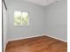 Comfortable bedroom with hardwood floors, a window, and a closet at 10305 Worthy Lamb Way, New Port Richey, FL 34654