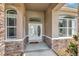 Welcoming front entrance with double doors framed by decorative stone and sidelight windows at 10305 Worthy Lamb Way, New Port Richey, FL 34654